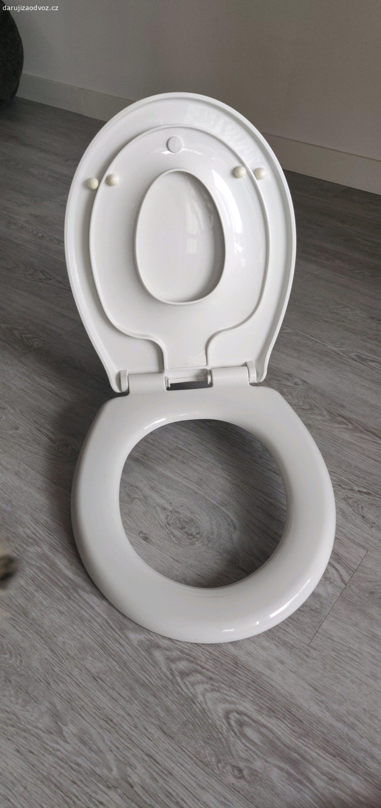 Záchodové prkýnko s redukcí. Daruji záchodové prkénko s vestavěnou dětskou redukcí. Zavírání s brzdou - nespadne, ale měkce dosedne. Vnější rozměr 44x37 cm.